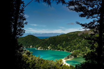 Scenic view of lake and mountains against blue sky