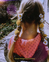 Full length rear view of woman with pink flower