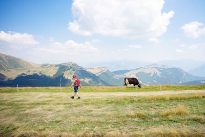 Scenic view of landscape against cloudy sky