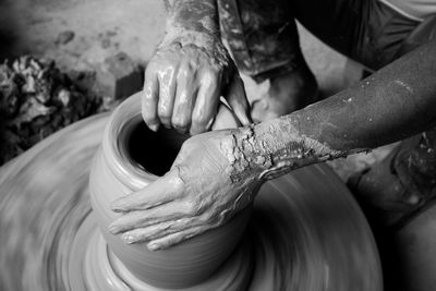 Cropped image of man making pottery at workshop