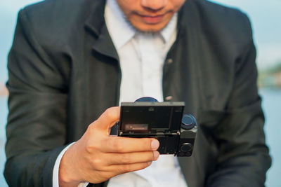 Midsection of man photographing
