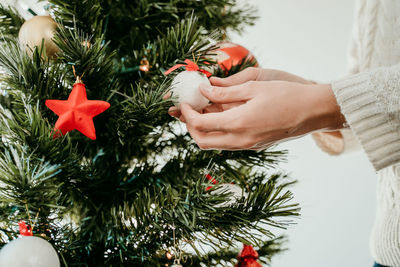 Midsection of person with christmas tree