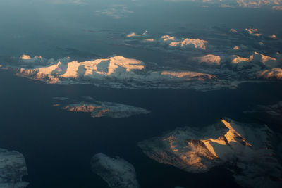 Aerial view of mountain range against sky during sunset