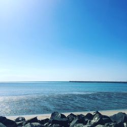 Scenic view of sea against clear blue sky