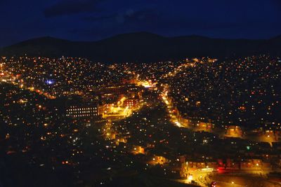 Aerial view of illuminated cityscape at night