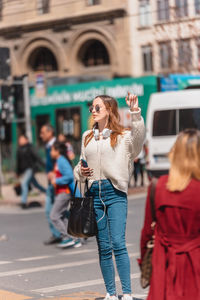 Woman with umbrella on street in city