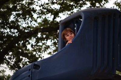 Portrait of a young boy on play equipment