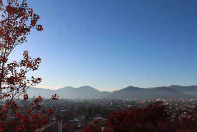 Aerial view of townscape against clear blue sky