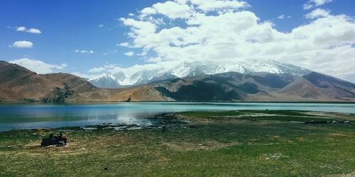 Scenic view of lake and mountains against sky