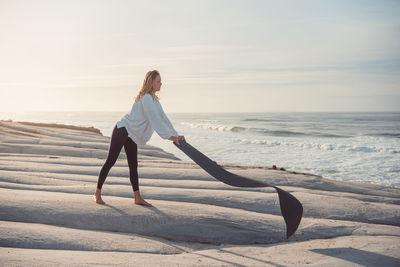 Full length of woman on beach during sunset