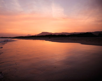 Scenic view of sea against romantic sky at sunset