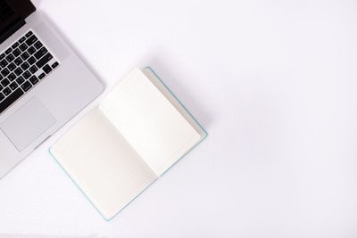 High angle view of laptop and book on table