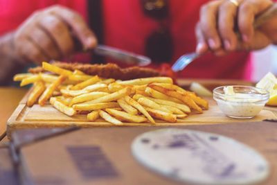 Midsection of man having food at table