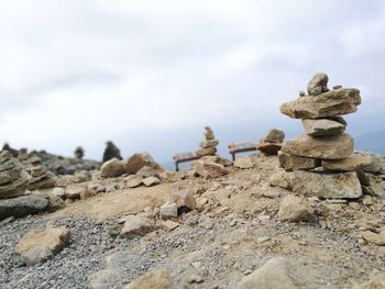 Stack of rocks on beach against sky