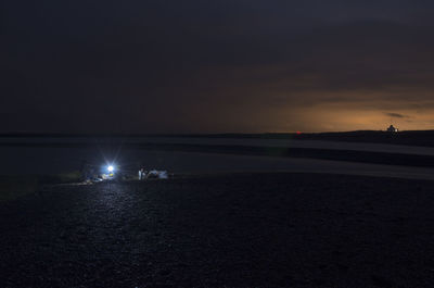 Scenic view of sea against sky at night