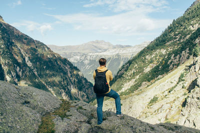 Woman standing on mountain against sky