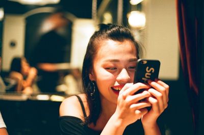 Portrait of young woman using mobile phone