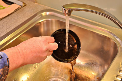 Close-up of hand pouring water