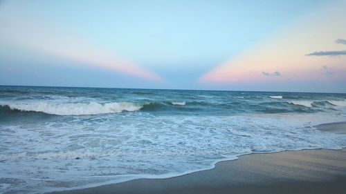 Scenic view of beach against sky during sunset