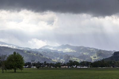 Scenic view of landscape and mountains against sky