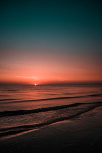 Scenic view of sea against romantic sky at sunset