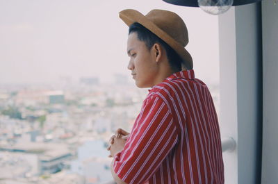 Side view of thoughtful man looking away on balcony