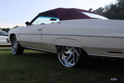 Vintage car on field against clear sky