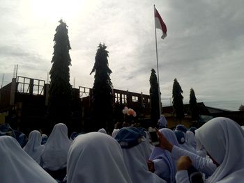 People at temple against sky