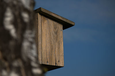 Low angle view of birdhouse against sky