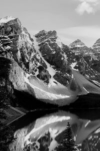 Monochrome scenic view of snowcapped mountains against sky