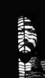 Close-up portrait of woman in darkroom