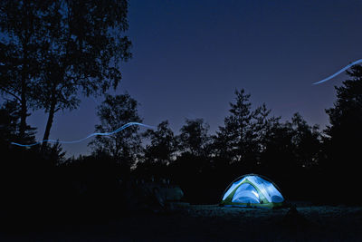 Illuminated tent in the forest of fontainebleau close to paris