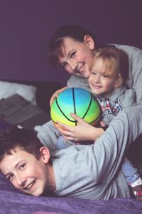 Portrait of happy siblings and woman