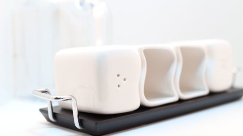 Close-up of slat shakers in tray on table