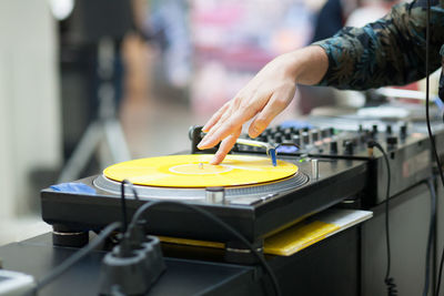 Cropped hand of woman mixing sound in recording studio