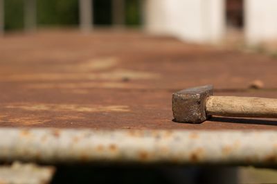 Hammer on rusty workbench