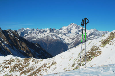 Scenic view of snowcapped mountains against clear blue sky