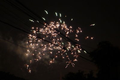 Low angle view of firework display at night