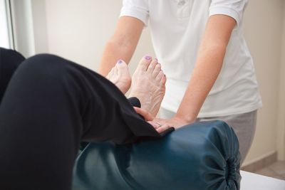 Midsection of couple holding hands