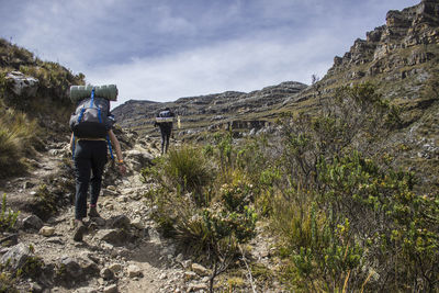 Rear view of people hiking on sierra nevada del cocuy against sky