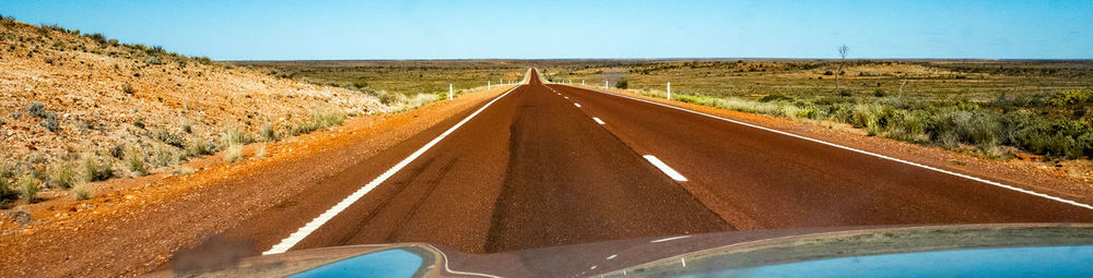 Road amidst landscape against clear sky