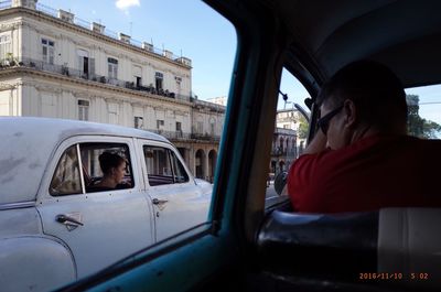 People sitting in car against sky