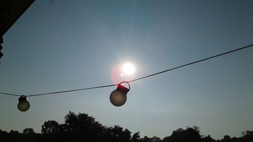 Light bulb with sun in background