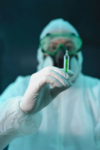 Close-up of doctor holding syringe 