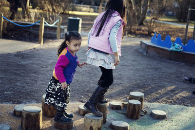 Two sisters playing on playground