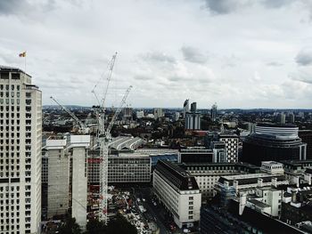 View of cityscape against cloudy sky