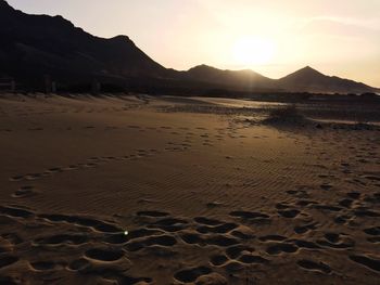 Scenic view of beach against sky during sunset