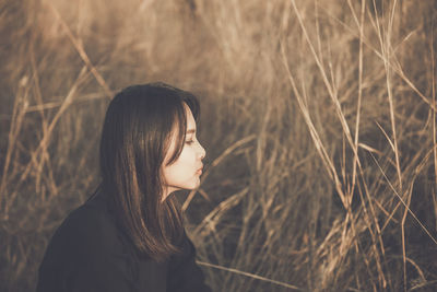 Side view of young woman looking away