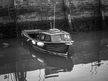 Sailboats moored on lake