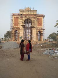 People at temple against clear sky